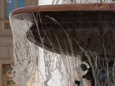 city fountain with granite bowl on a bright sunny day